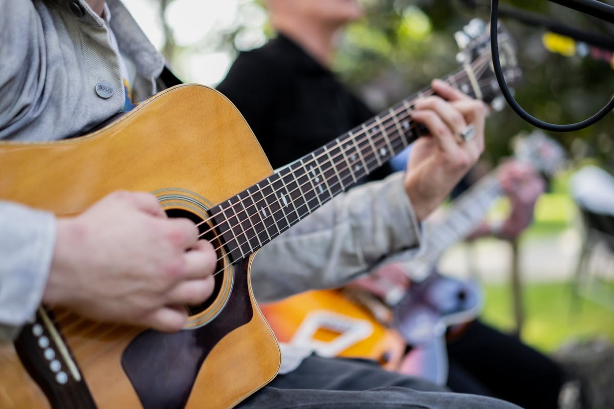 Close-up of a guitarist's hands on the strings during a performance